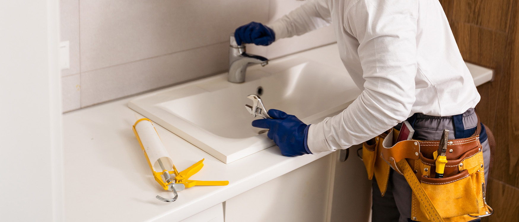 plumber servicing faucet